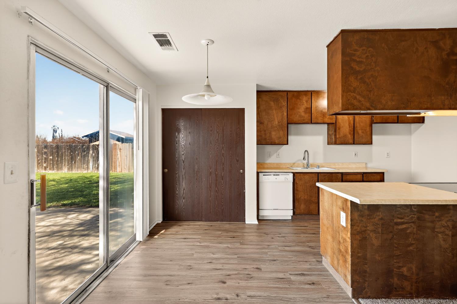 2915 Balsam Way Merced, CA 95348 - Photo 11 of 40 a kitchen with a sink refrigerator and cabinets