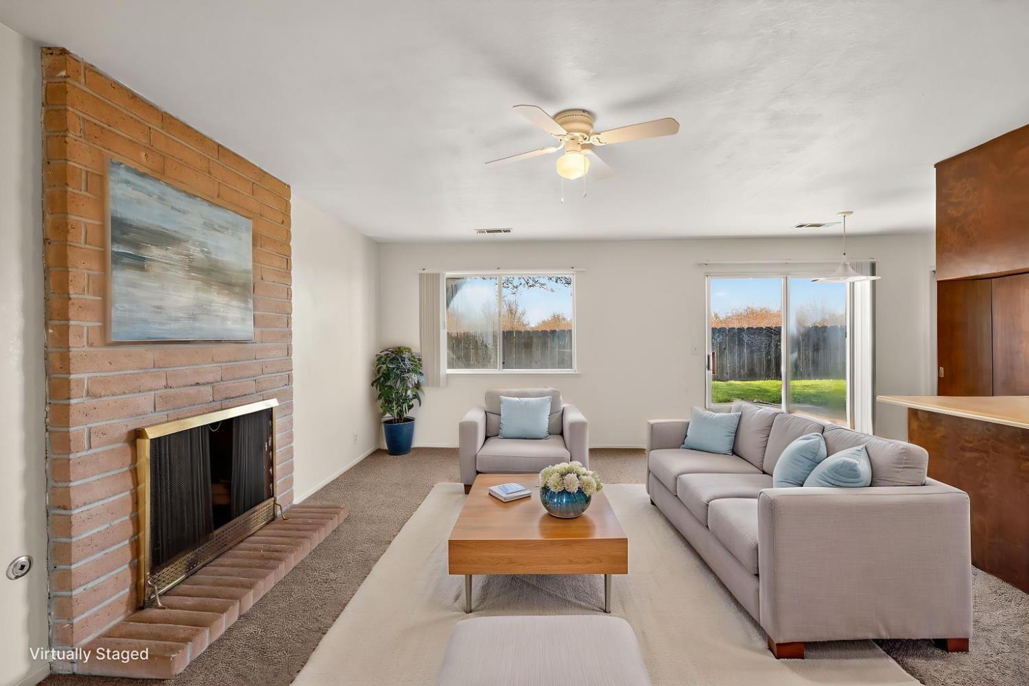 2915 Balsam Way Merced, CA 95348 - Photo 14 of 40 a living room with furniture and a fireplace