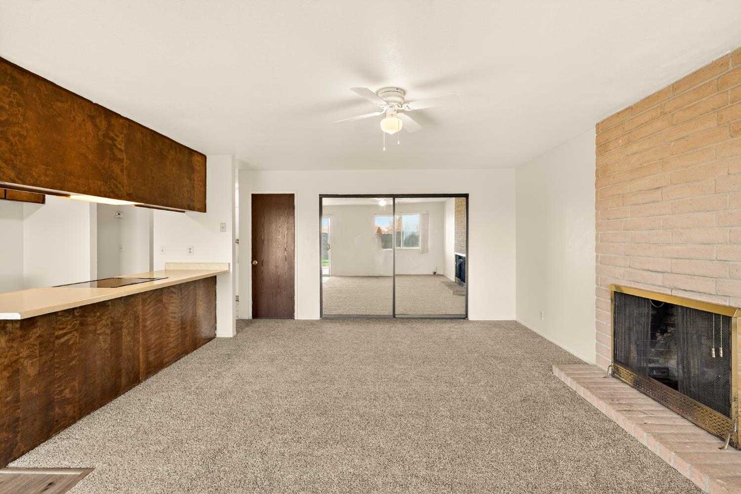 2915 Balsam Way Merced, CA 95348 - Photo 16 of 40 a view of a kitchen with a sink and a fireplace