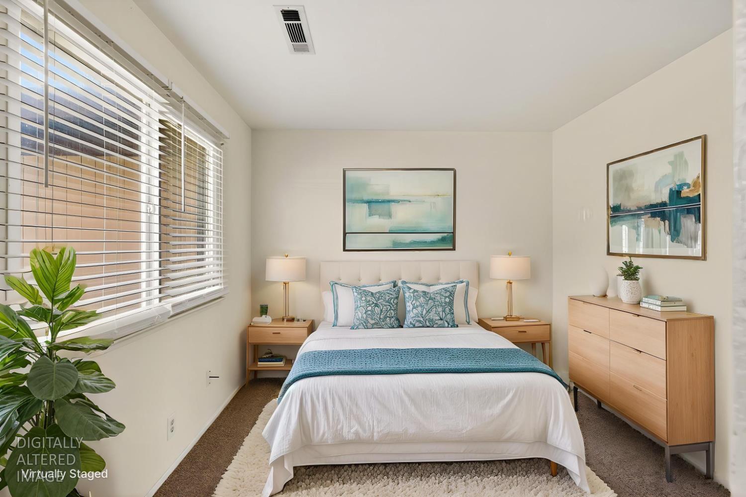 2915 Balsam Way Merced, CA 95348 - Photo 23 of 40 a bedroom with a large bed a potted plant and a window