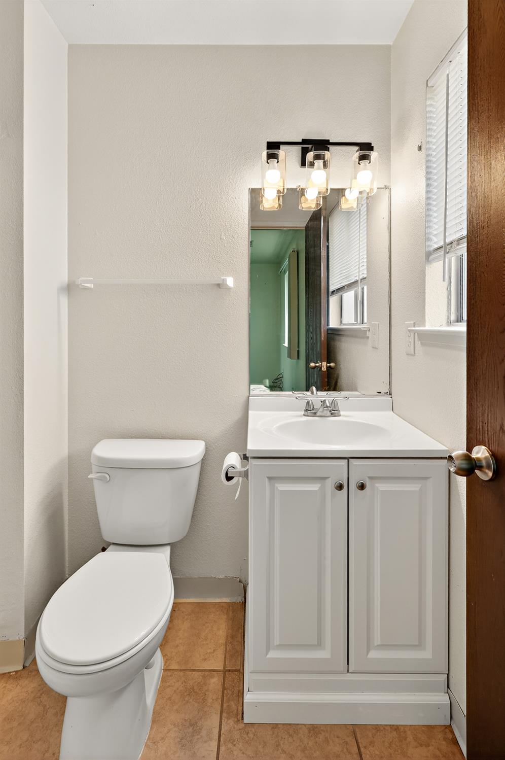 2915 Balsam Way Merced, CA 95348 - Photo 26 of 40 a bathroom with a toilet sink and mirror