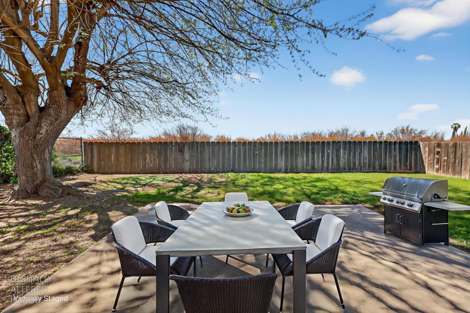 2915 Balsam Way Merced, CA 95348 - Photo 32 of 40 a view of a patio with a table chairs and a fire pit