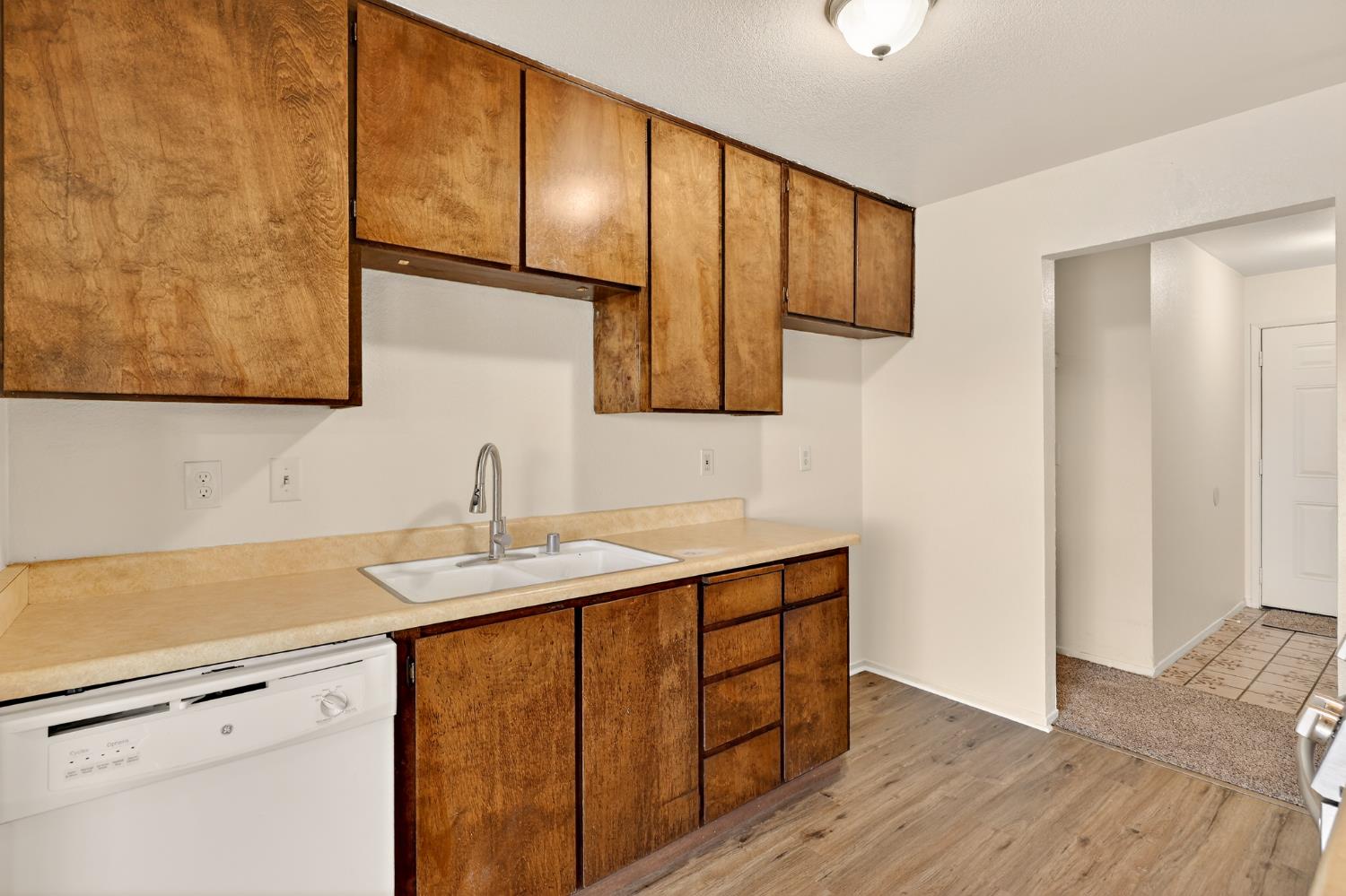 2915 Balsam Way Merced, CA 95348 - Photo 7 of 40 a kitchen with a sink cabinets and wooden floor
