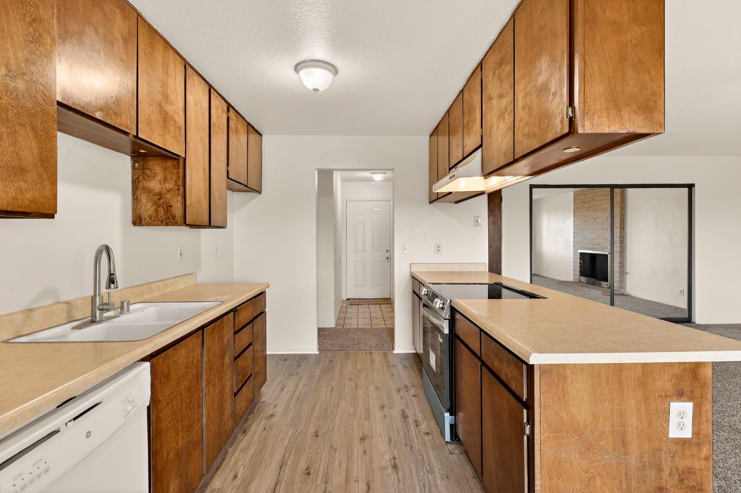 2915 Balsam Way Merced, CA 95348 - Photo 8 of 40 a kitchen with a sink and wooden cabinets