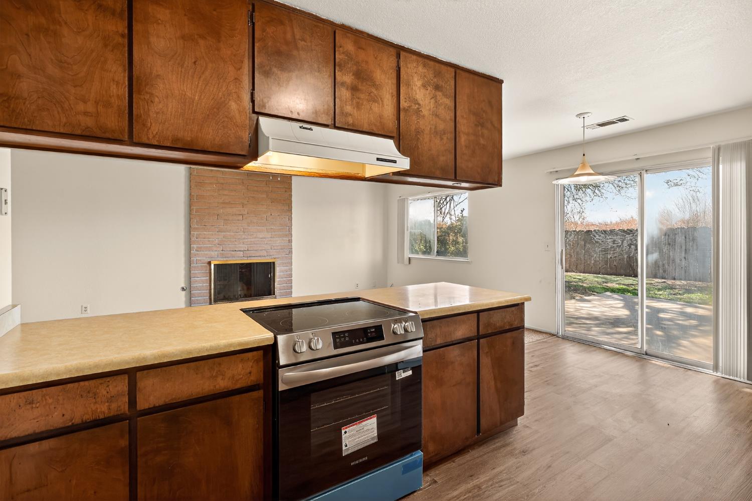 2915 Balsam Way Merced, CA 95348 - Photo 9 of 40 a kitchen with a stove and a microwave