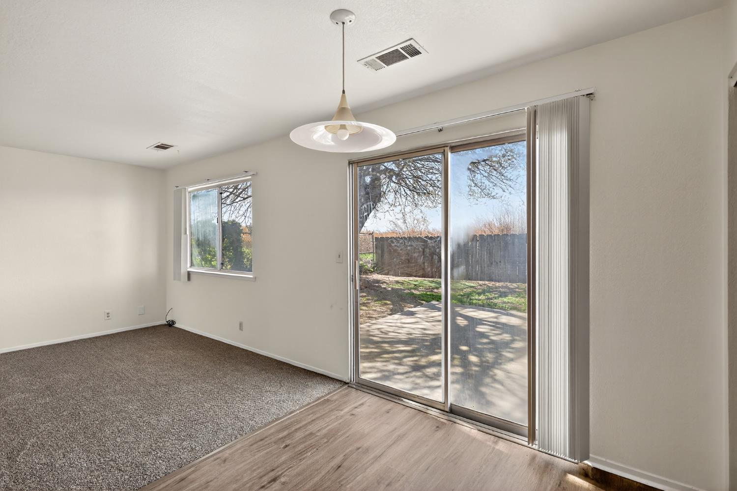 2915 Balsam Way Merced, CA 95348 - Photo 10 of 40 an empty room with windows and outdoor view
