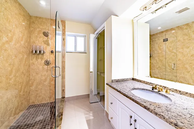 a bathroom with a sink toilet and shower