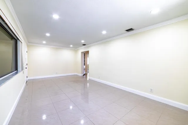 an empty room with a window and natural light