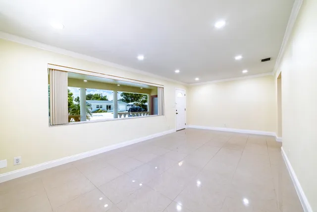 an empty room with windows and entrance