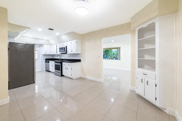 a kitchen with stainless steel appliances a refrigerator and a stove top oven