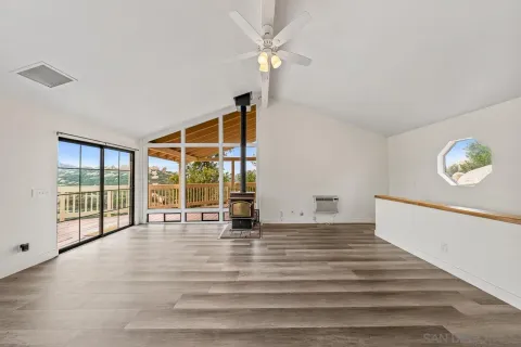 a view of a room with wooden floor and white walls