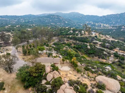 an aerial view of a house with a yard and balcony