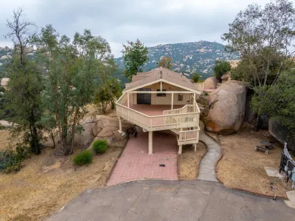 an aerial view of a house with a yard