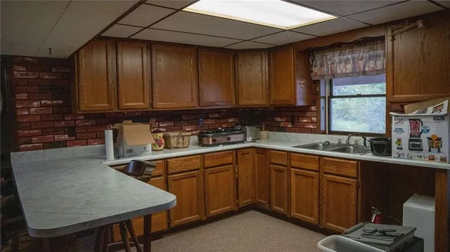 a kitchen with a table chairs refrigerator and cabinets