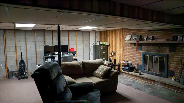 a living room with furniture a ceiling fan and a window