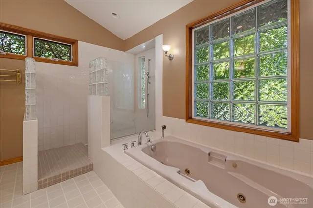 a bathroom with a bathtub and shower