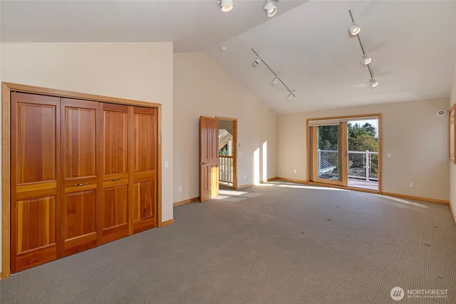 a view of a room with furniture and windows