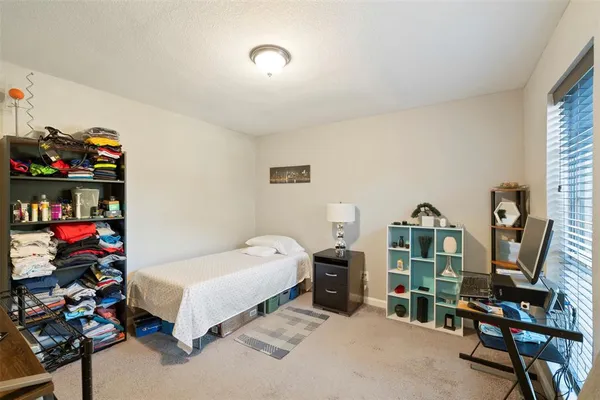 a bedroom with bed and a window
