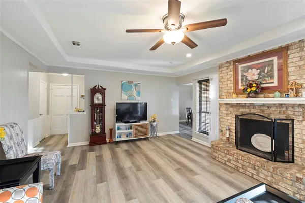 a living room with furniture a fireplace and a flat screen tv