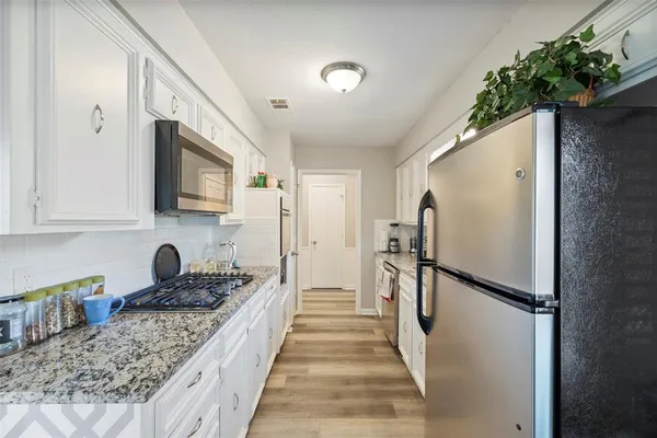 a kitchen with a refrigerator and a sink