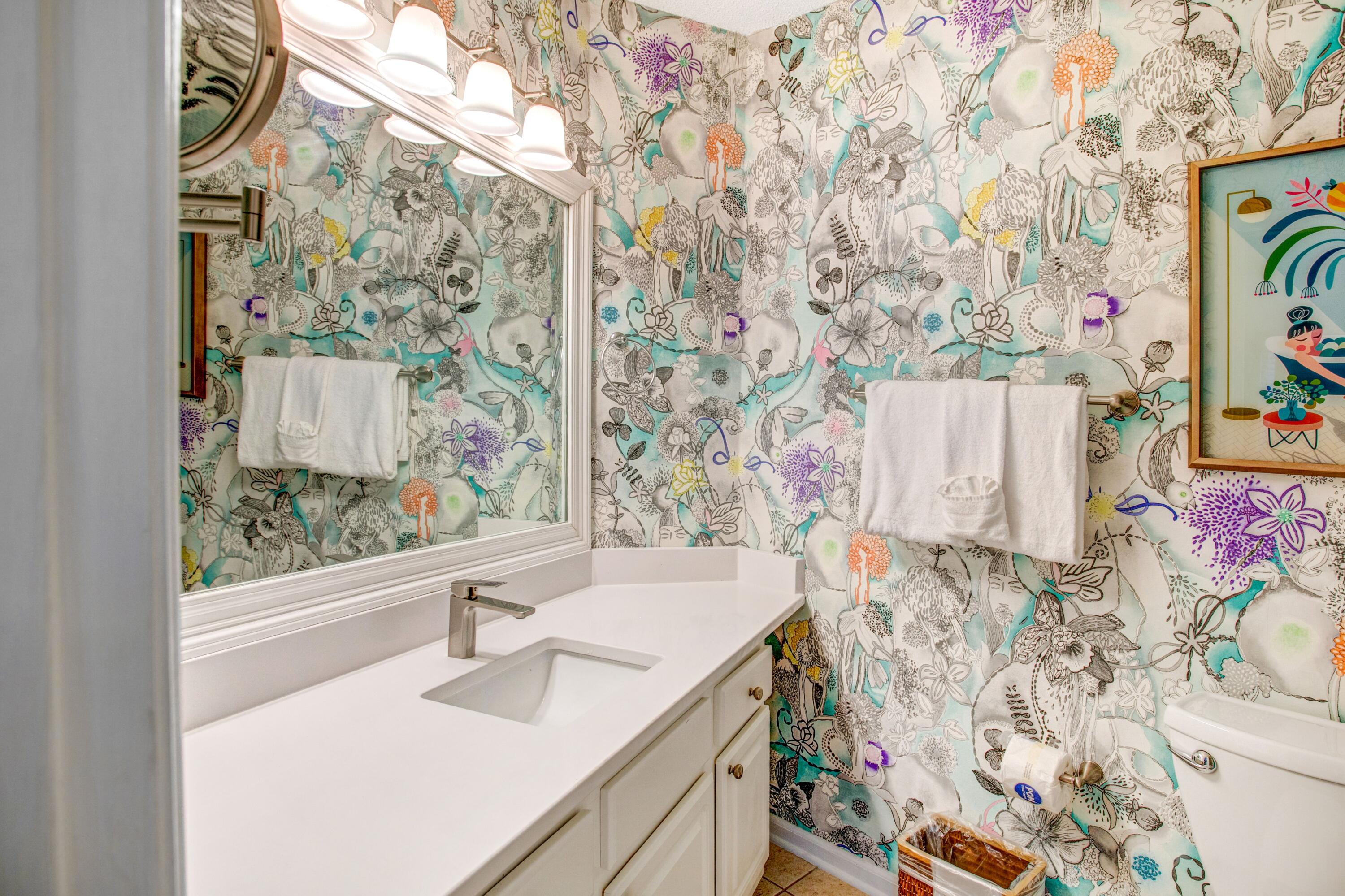 285 Payne Street, Unit 5A Miramar Beach, FL 32550 - Photo 11 of 20 a bathroom with a sink and a large mirror with painted walls