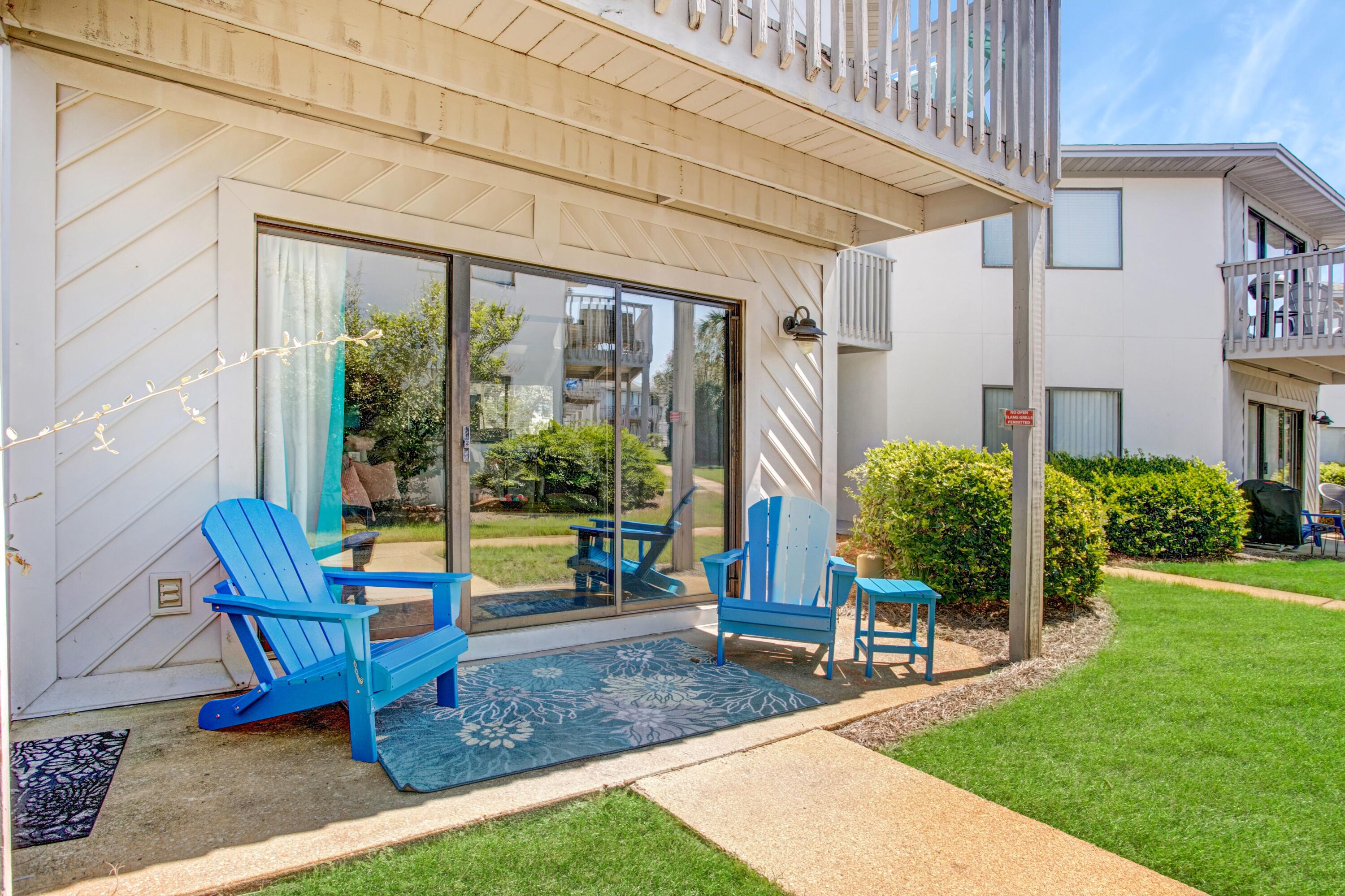 285 Payne Street, Unit 5A Miramar Beach, FL 32550 - Photo 16 of 20 a view of a chair and table in backyard of the house