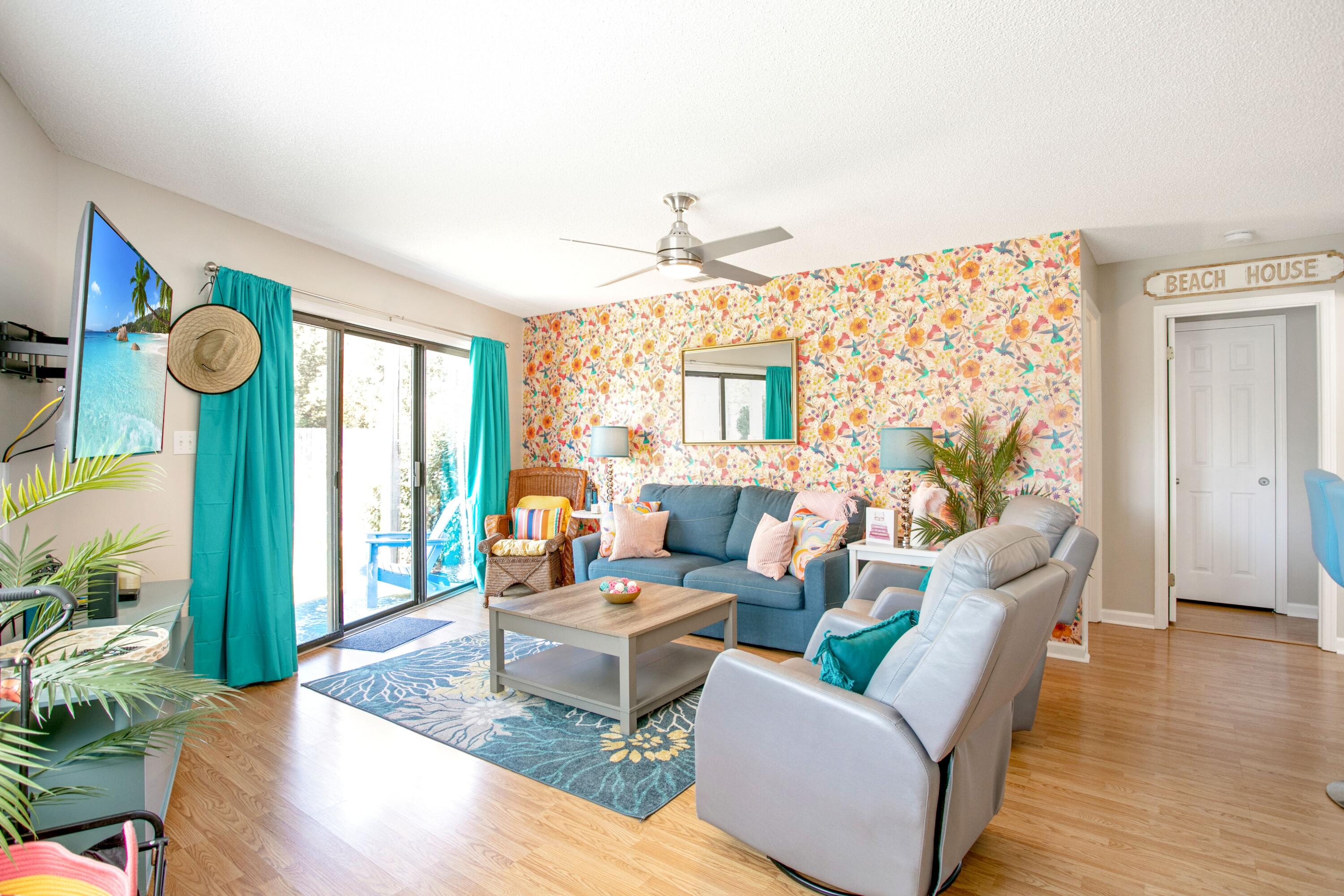 285 Payne Street, Unit 5A Miramar Beach, FL 32550 - Photo 6 of 20 a living room with furniture a chandelier and a window