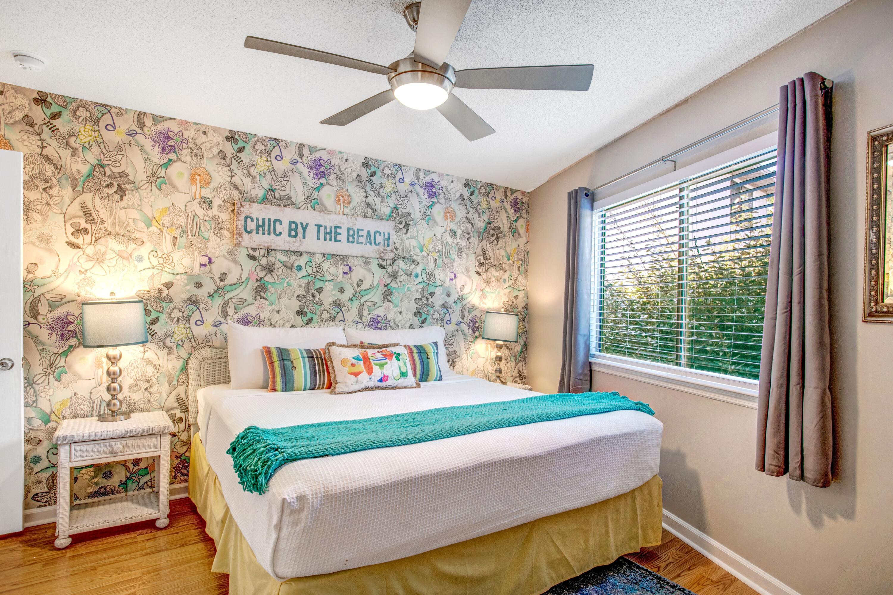 285 Payne Street, Unit 5A Miramar Beach, FL 32550 - Photo 8 of 20 a bedroom with a large bed and a chandelier