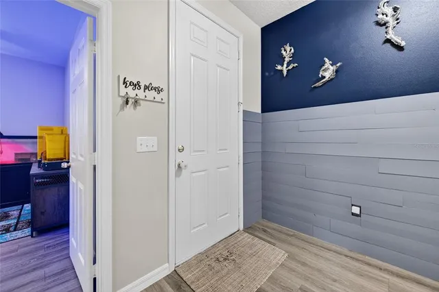 a view of an entryway with wooden floor