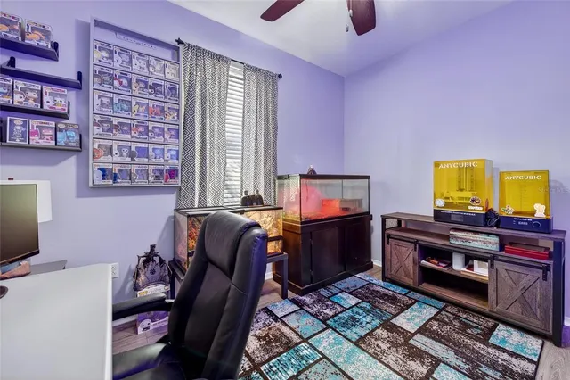 a view of a workspace with furniture and a window