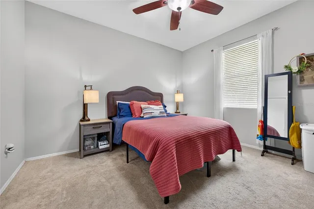 a spacious bedroom with a bed and a chandelier
