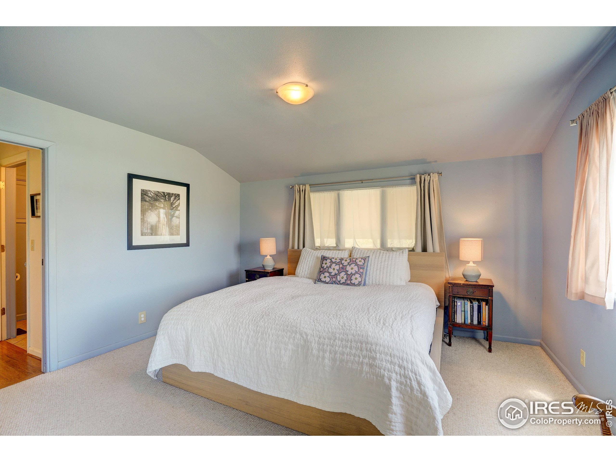 5196 Oxford Road Longmont, CO 80503 - Photo 26 of 38 a bedroom with a bed and a table