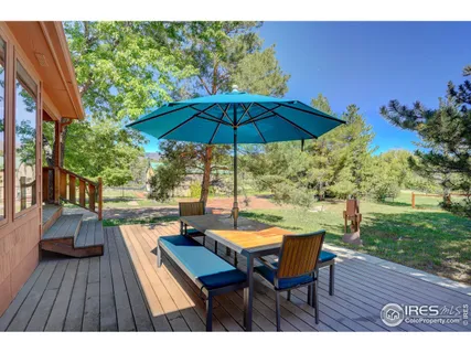 a view of a patio with a table and chairs under an umbrella