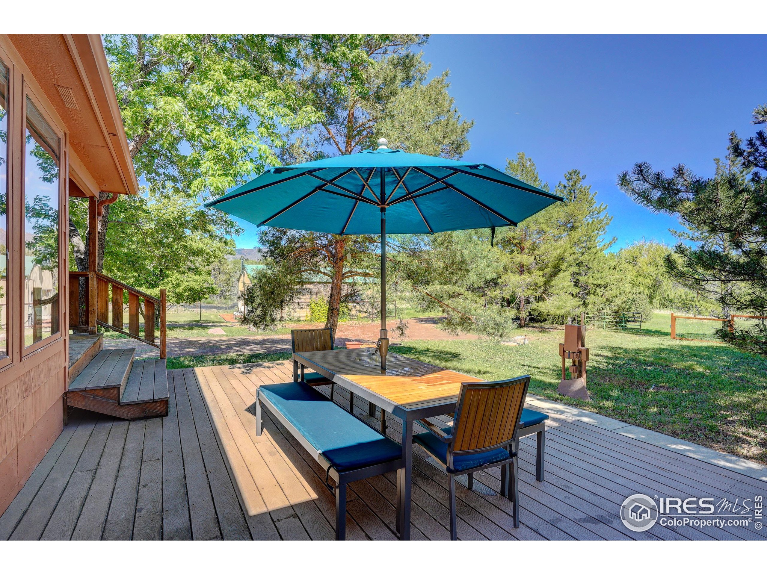 5196 Oxford Road Longmont, CO 80503 - Photo 29 of 38 a view of a chairs and table under an umbrella in backyard