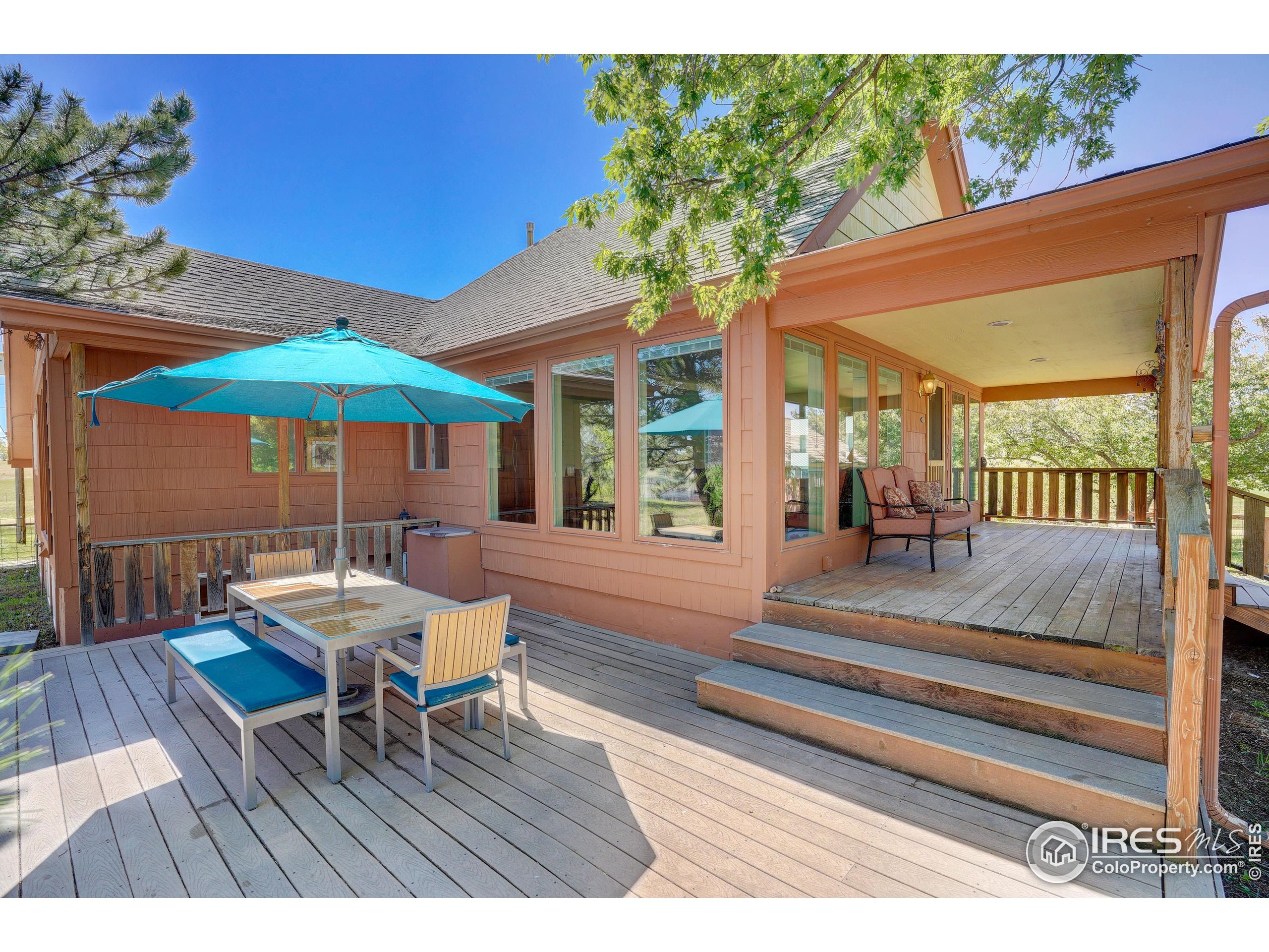 5196 Oxford Road Longmont, CO 80503 - Photo 30 of 38 a view of a patio with a table and chairs under an umbrella