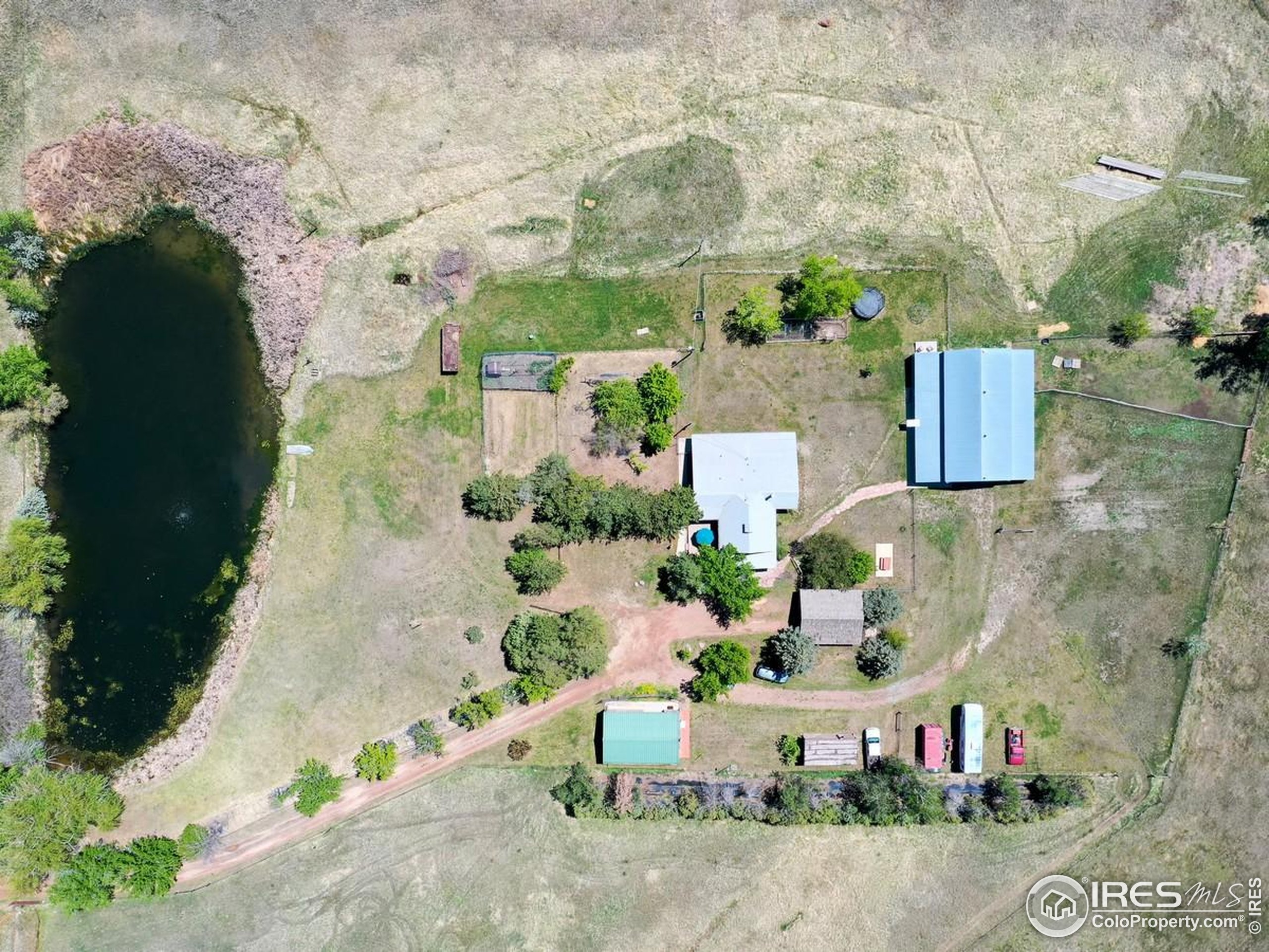 5196 Oxford Road Longmont, CO 80503 - Photo 8 of 38 an aerial view of a house with a yard and large tree