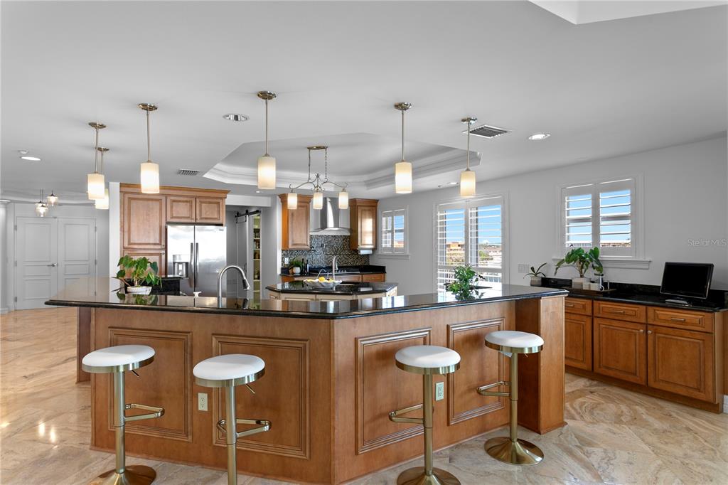 19730 Gulf Boulevard, Unit 400 Indian Rocks Beach, FL 33785 - Photo 33 of 90 a large kitchen with a table and chairs