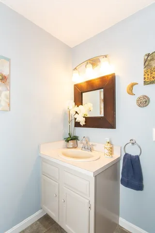 a bathroom with a sink vanity and mirror