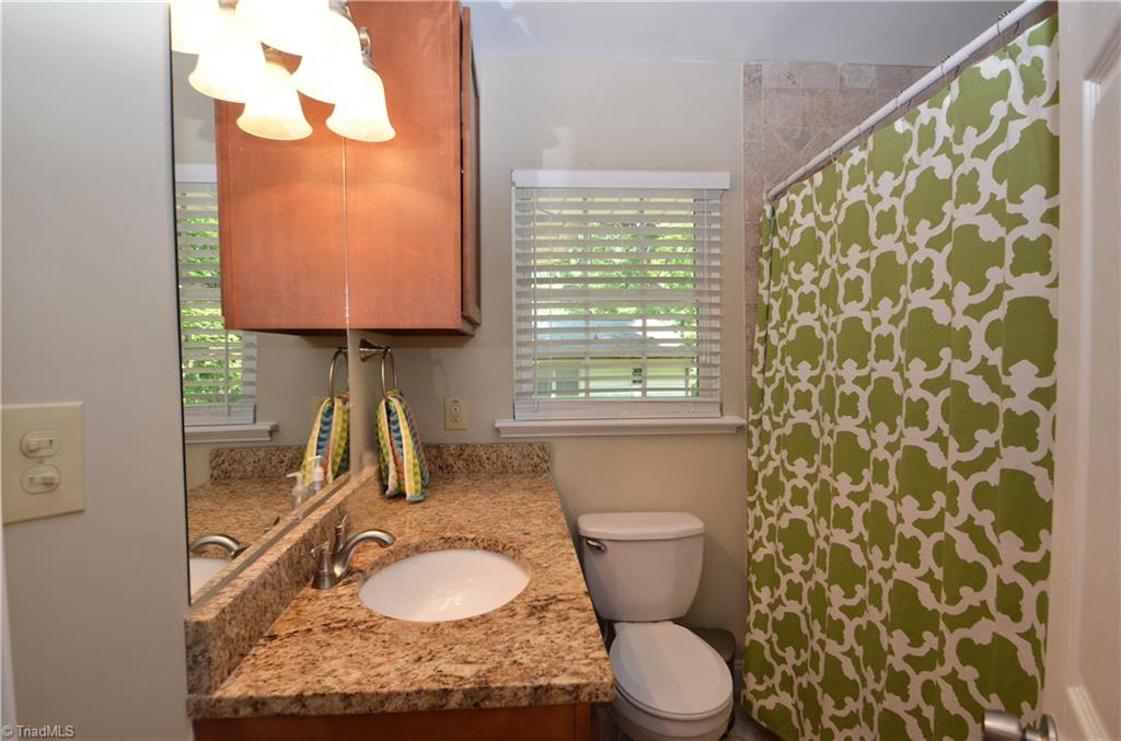 1025 Huntingdon Road Winston-Salem, NC 27104 - Photo 16 of 26 Hall bath with granite counter and tiled tub.