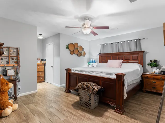 a bedroom with a bed and a chandelier