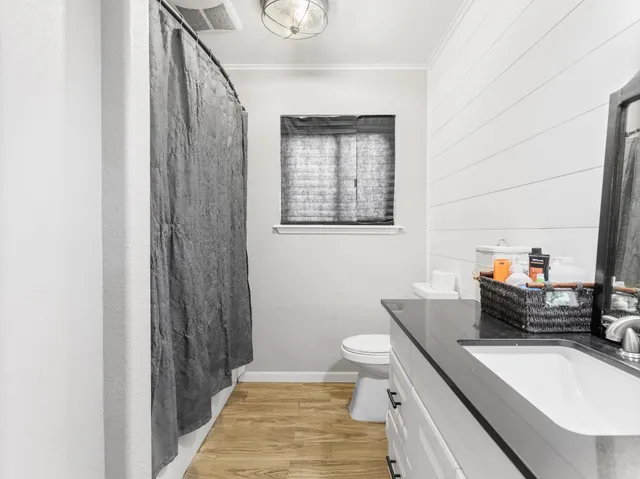 a bathroom with a sink toilet and shower