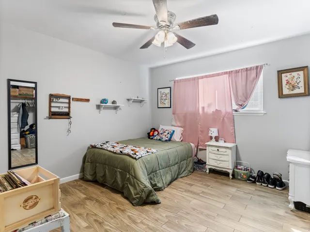 a bedroom with a bed and a window