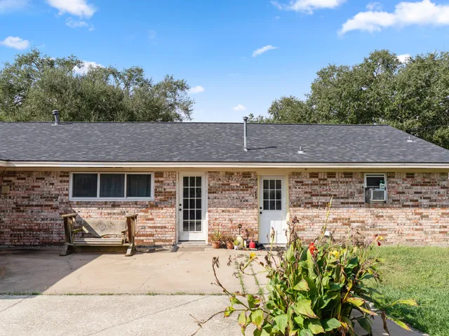 a front view of house with yard outdoor seating and barbeque oven