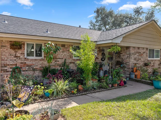 a view of a house with plants and a patio