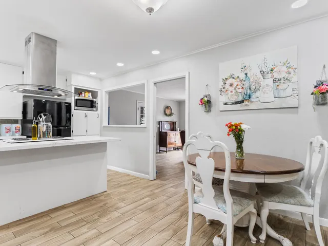 a dining room with furniture and wooden floor