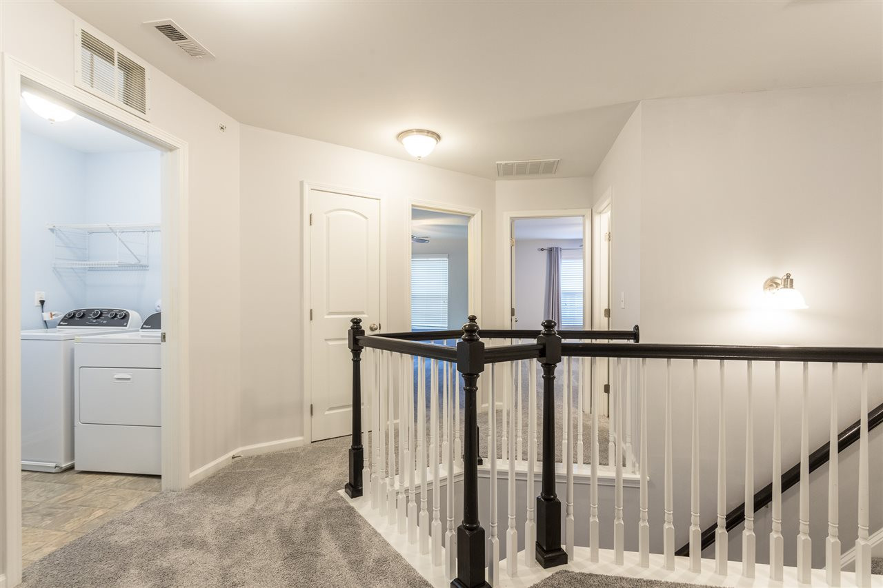 9929 Lynnberry Place Raleigh, NC 27617 - Photo 18 of 30 The lovely staircase leads to the second floor with 3 bedrooms, a laundry room, hall bath and a linen closet. Upstairs Landing