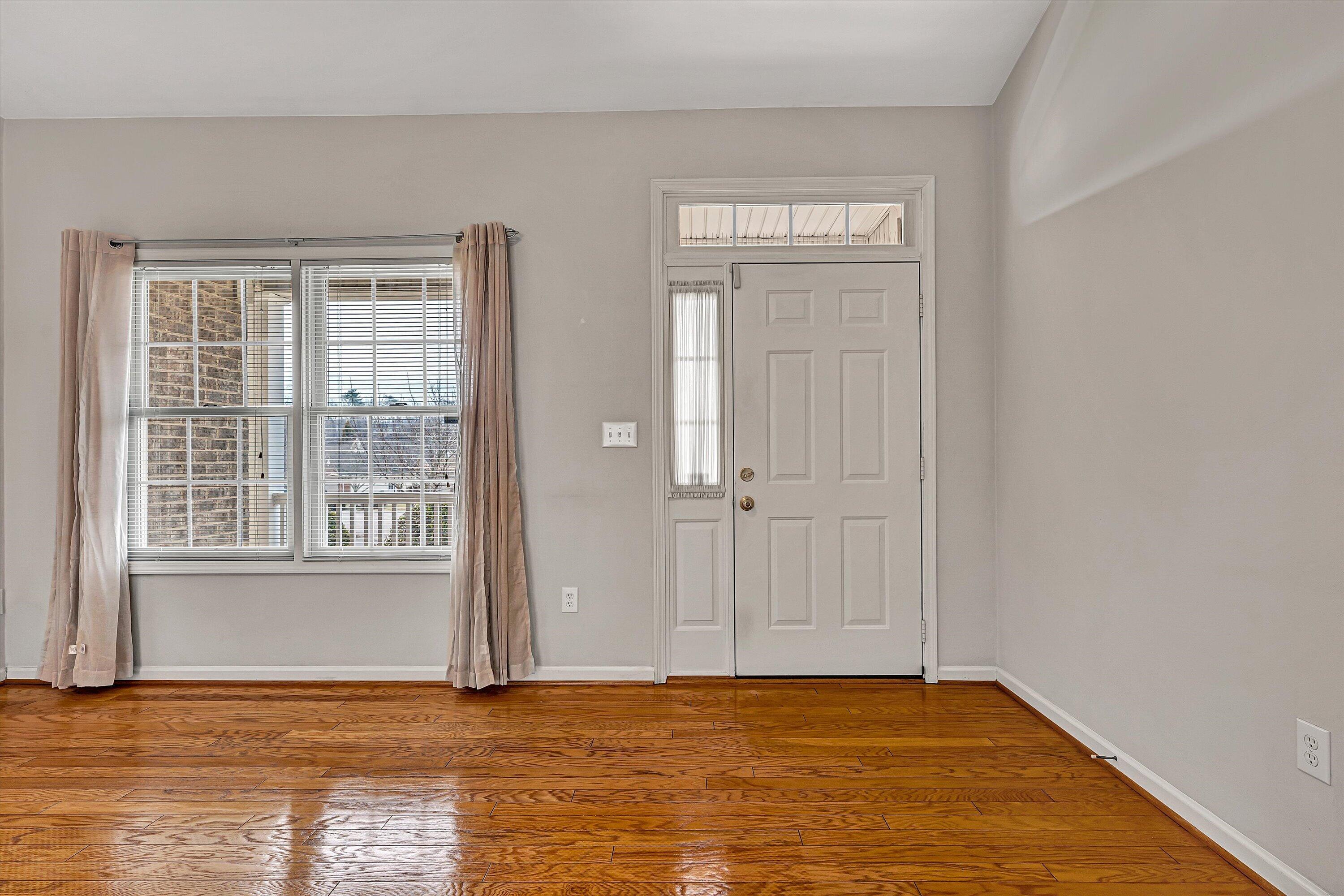 1365 Aarons Run Circle Salem, VA 24153 - Photo 6 of 35 a view of an empty room with wooden floor and a window