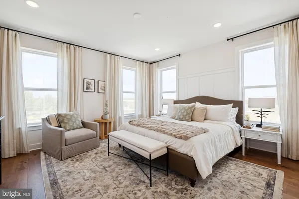 a spacious bedroom with a bed and a couch