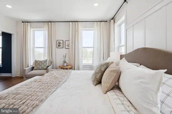 a bedroom with a large bed and a large window