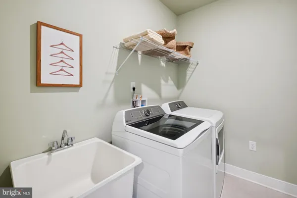 a bathroom with a sink and washing machine